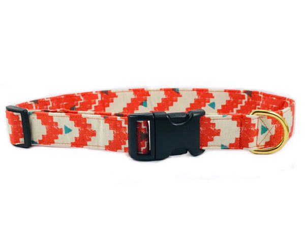 dog collar with orange and cream arrow print with small green triangles